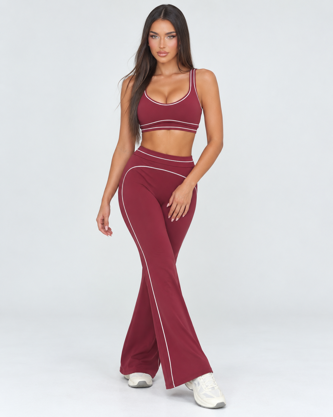 cherry women’s gym outfit with a fitted sports bra and high waisted flared activewear leggings, detailed with curved contrast seams and white piping for a body contouring workout, training and athleisure look