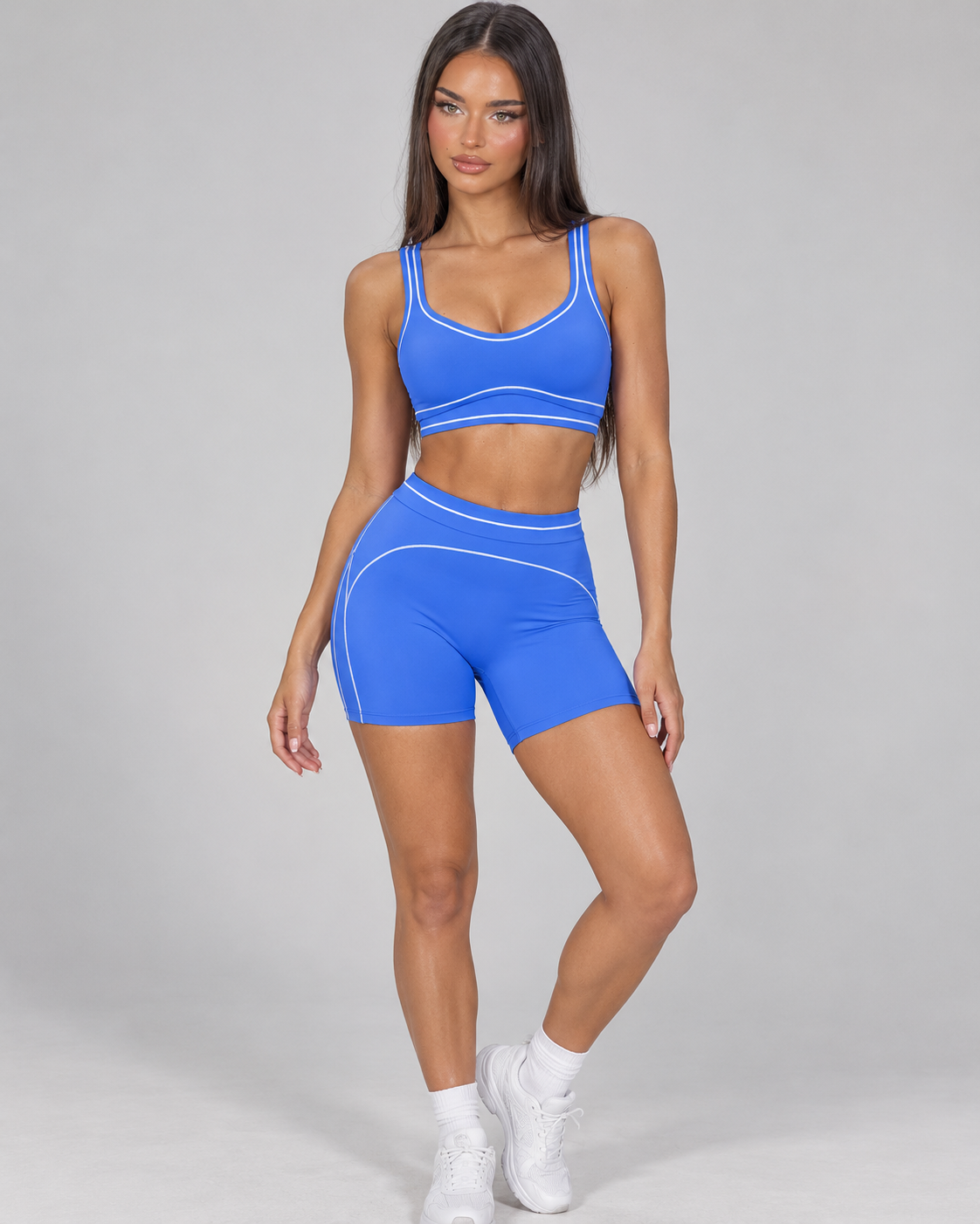 cobalt blue women’s activewear set featuring a supportive scoop neck training bra and high rise fitted gym shorts with flattering curved seam details, designed for exercise, fitness training and athleisure wear