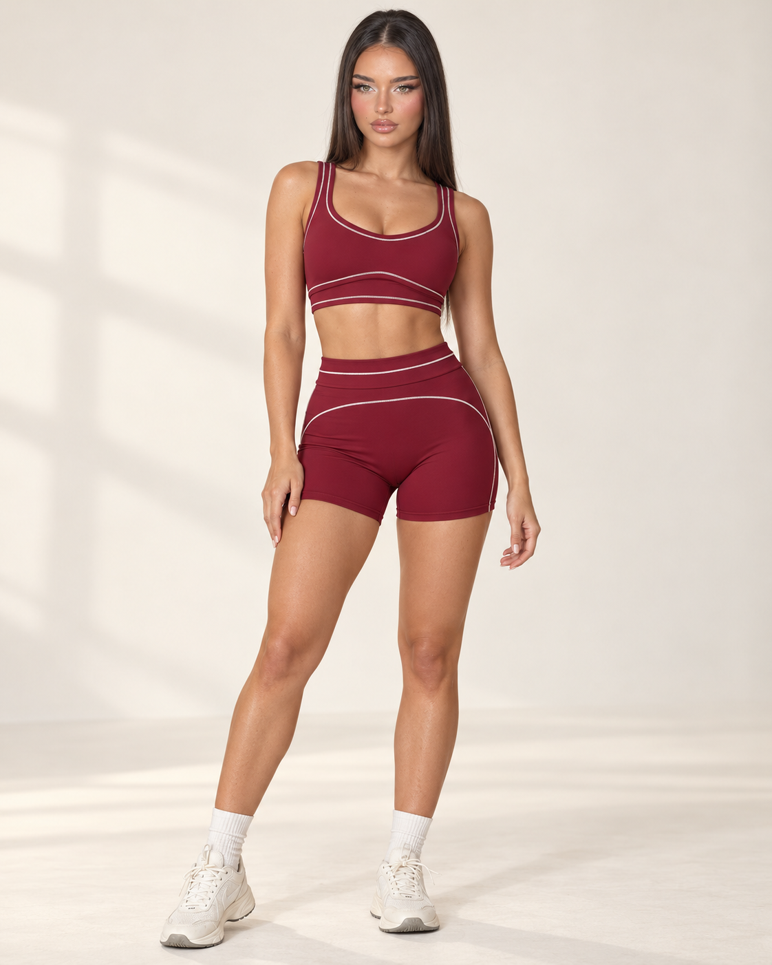 cherry red women’s activewear set featuring a supportive scoop neck training bra and high rise fitted gym shorts with flattering curved seam details, designed for exercise, fitness training and athleisure wear