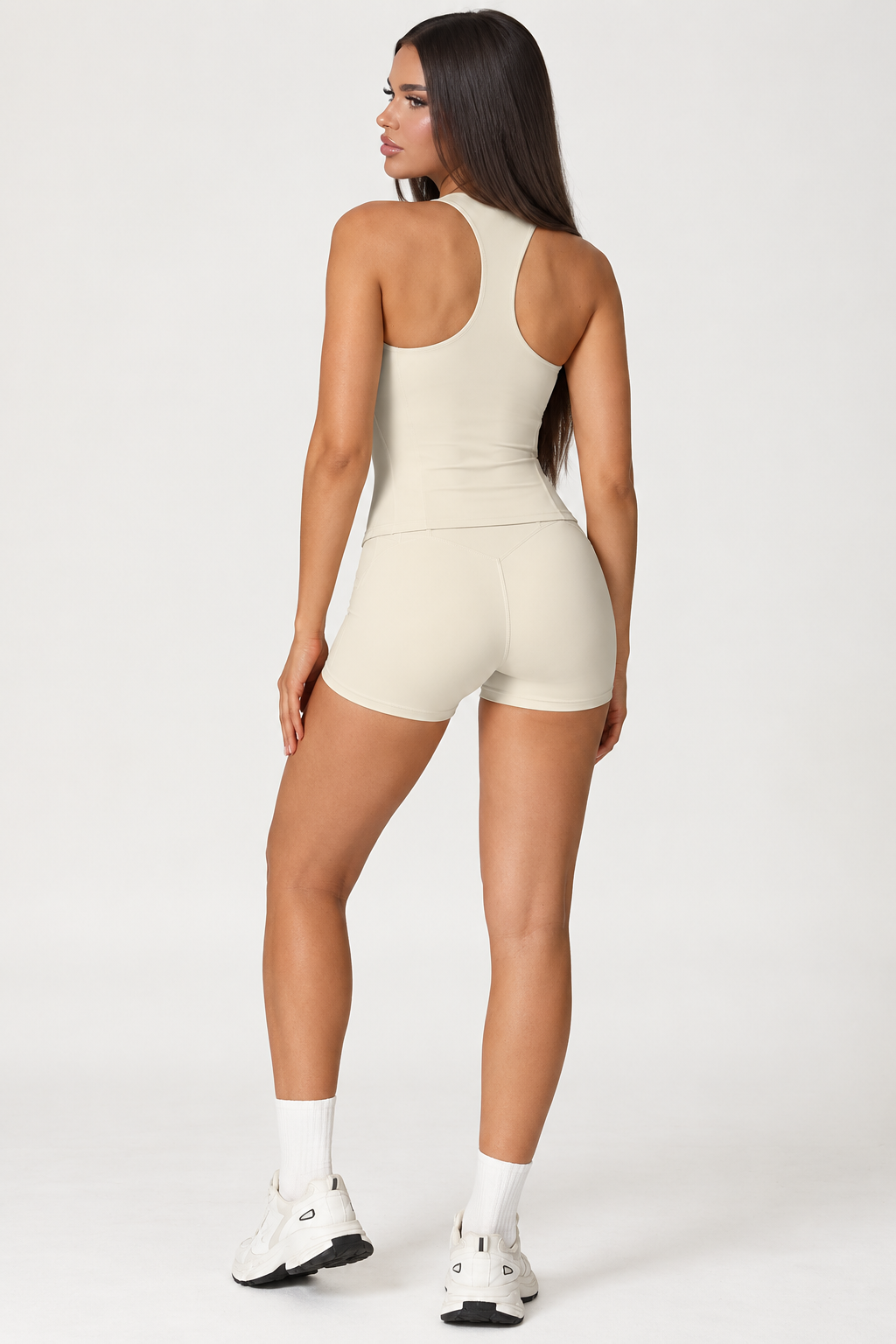 Women’s cream gym workout set with a sculpting square neck tank top and high waisted fitted activewear shorts, a minimalist matching fitness outfit for training, exercise, Pilates and everyday activewear