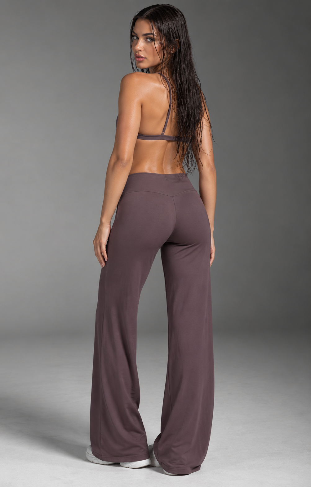 muted mauve-brown women’s gym set with an elegant strappy back sports bra and flattering high waist flow-leg trousers