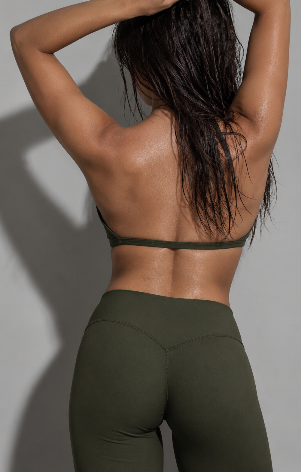 olive green women’s yoga set featuring a feminine V-neck training bra and fluid wide leg activewear pants