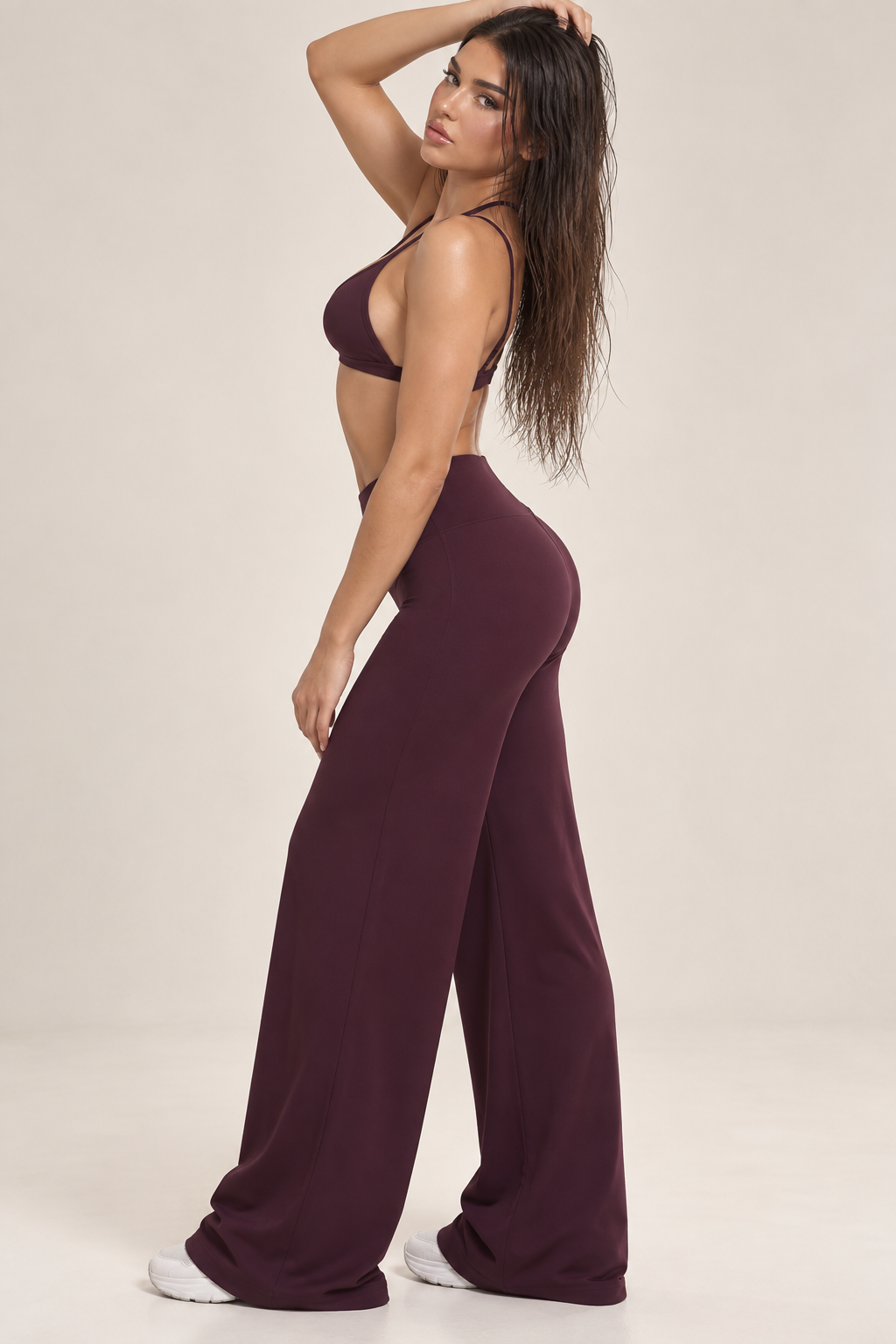 Merlot red women’s activewear co ord with delicate back straps, sculpting high rise waistband and flowing full length trousers