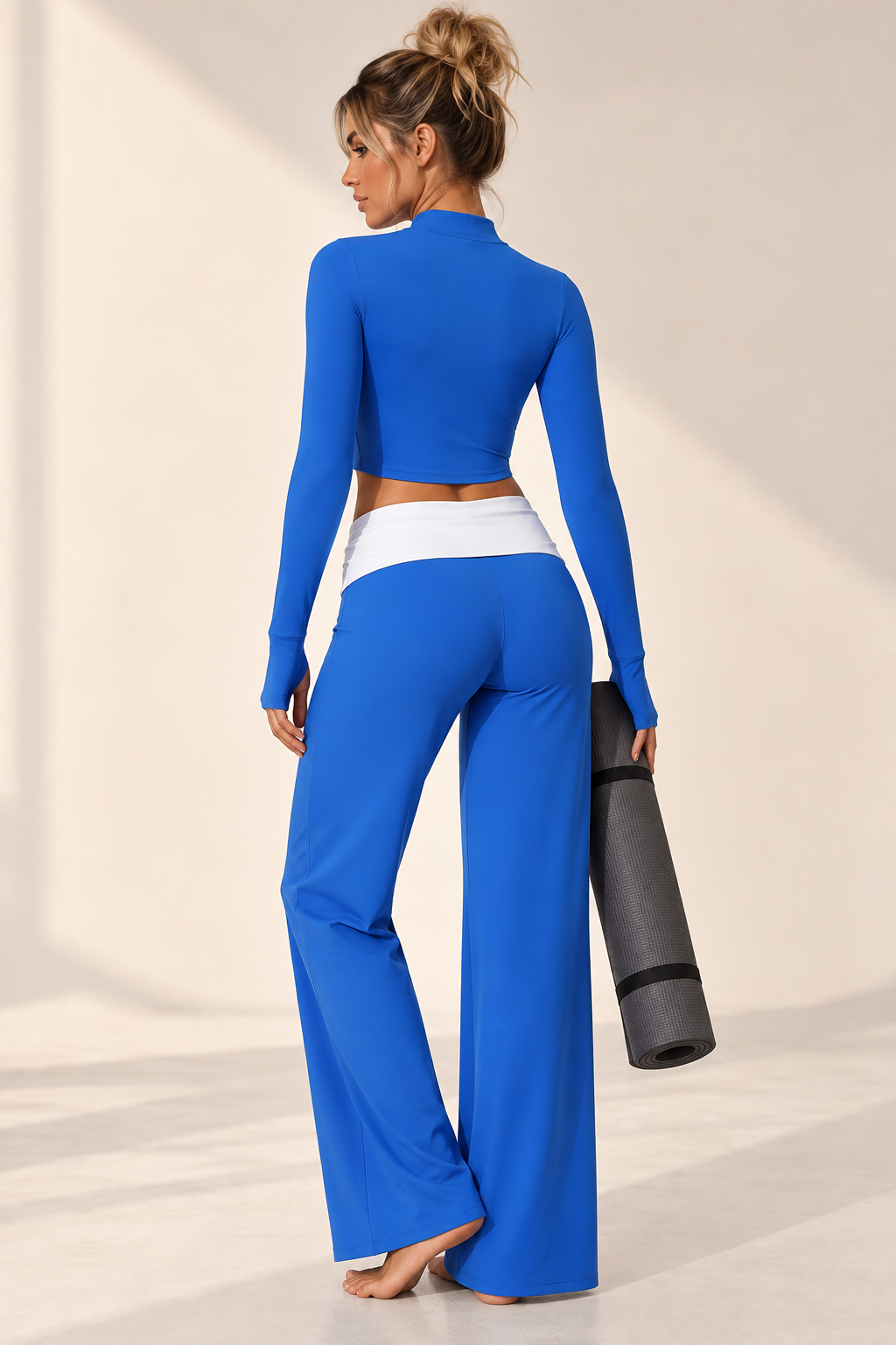 Brilliant blue women’s yoga outfit with thumbhole sleeves, a feminine V-front bra and relaxed high waist trousers finished with a crisp white waist panel