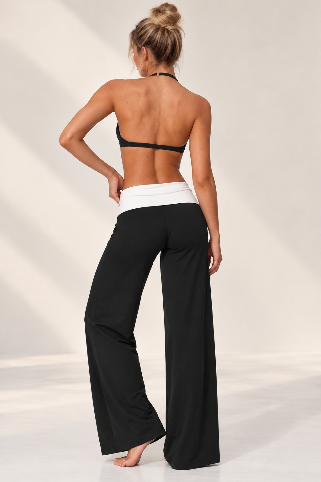 black women’s Pilates three piece featuring a sleek cropped performance jacket, matching training bra and fluid wide leg lounge pants