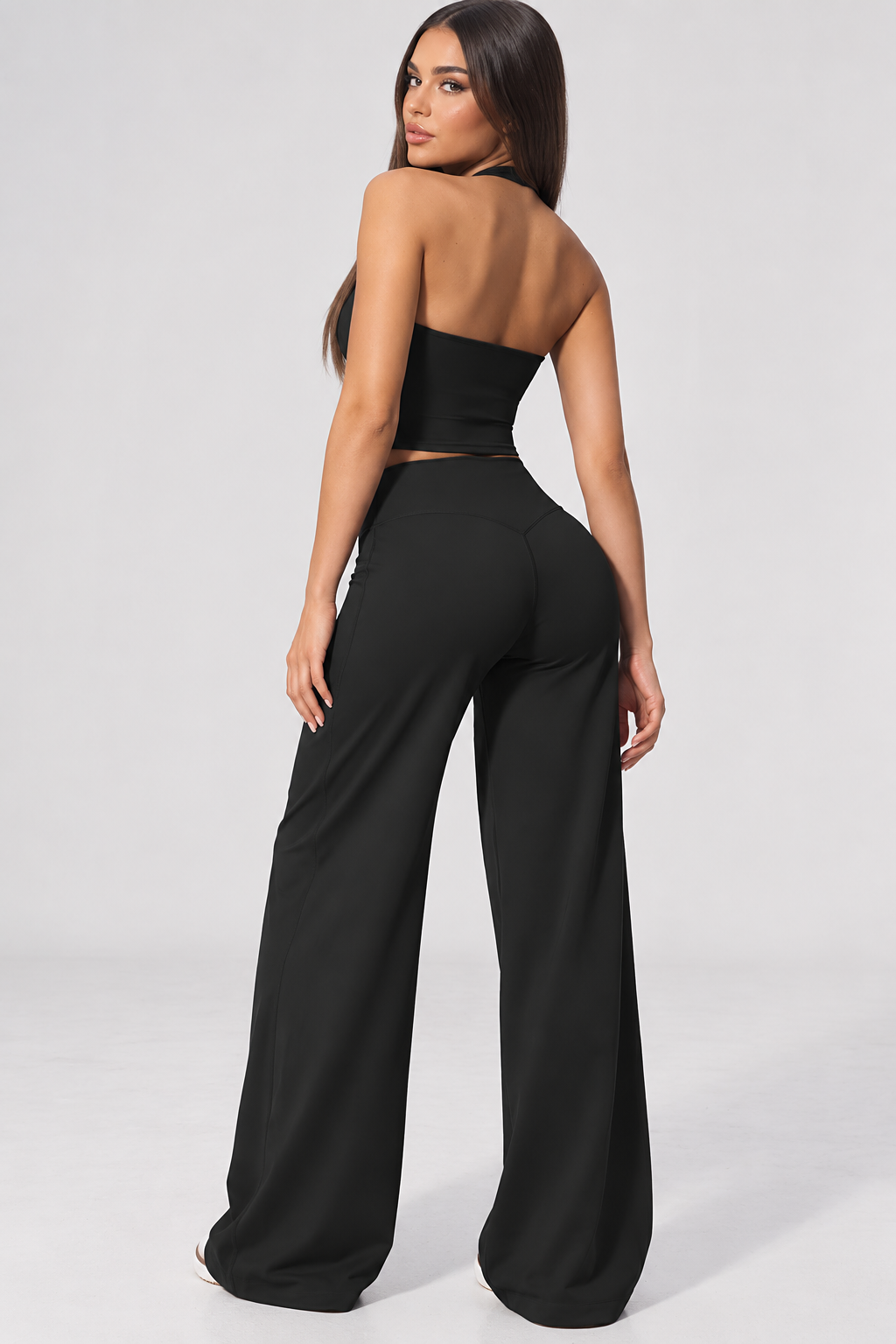 black women’s activewear set featuring a fitted halter neck workout top and high waisted wide leg gym pants, creating a bright coordinated fitness outfit for training, Pilates and athleisure