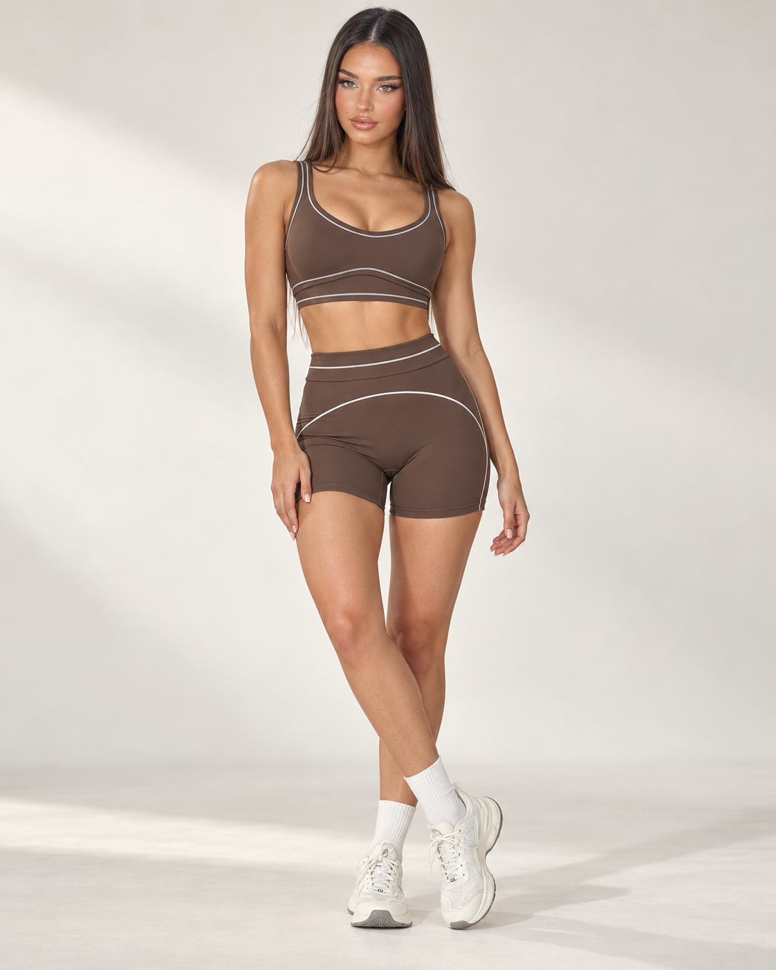 mocha women’s activewear set featuring a supportive scoop neck training bra and high rise fitted gym shorts with flattering curved seam details, designed for exercise, fitness training and athleisure wear