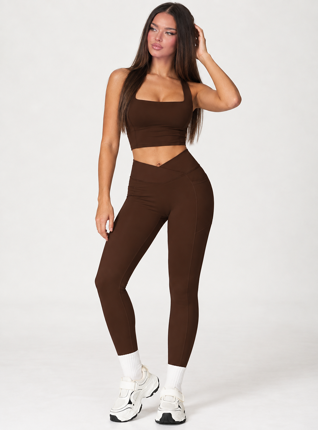 Women’s chocolate brown gym set with a fitted square neck athletic crop top and high waisted V crossover full length leggings, a sleek matching workout outfit for training, fitness and everyday activewear