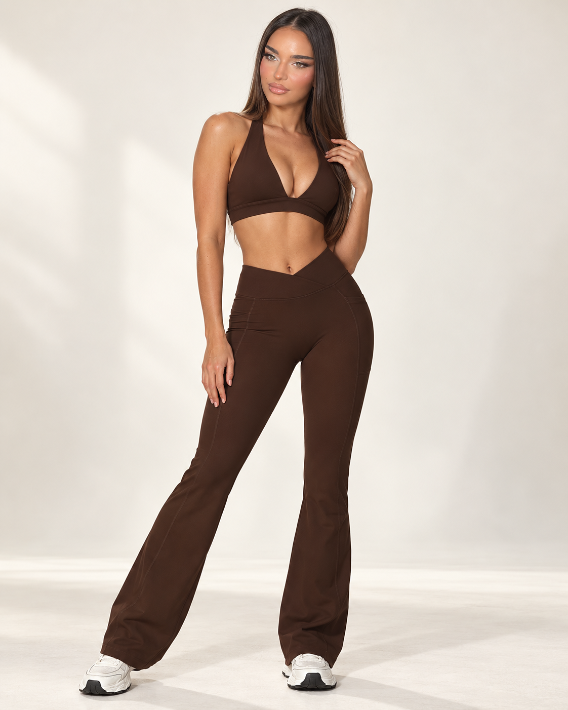 brown women’s activewear co ord with a fitted sleeveless square neck training top and full length high waisted sculpting leggings with crossover V waistband, a premium ERAFITT workout and athleisure set