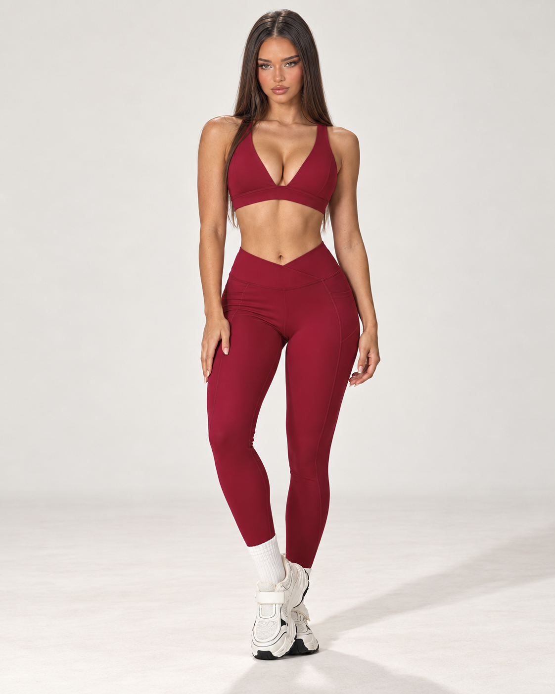 red women’s activewear co ord with a fitted sleeveless square neck training top and full length high waisted sculpting leggings with crossover V waistband, a premium ERAFITT workout and athleisure set