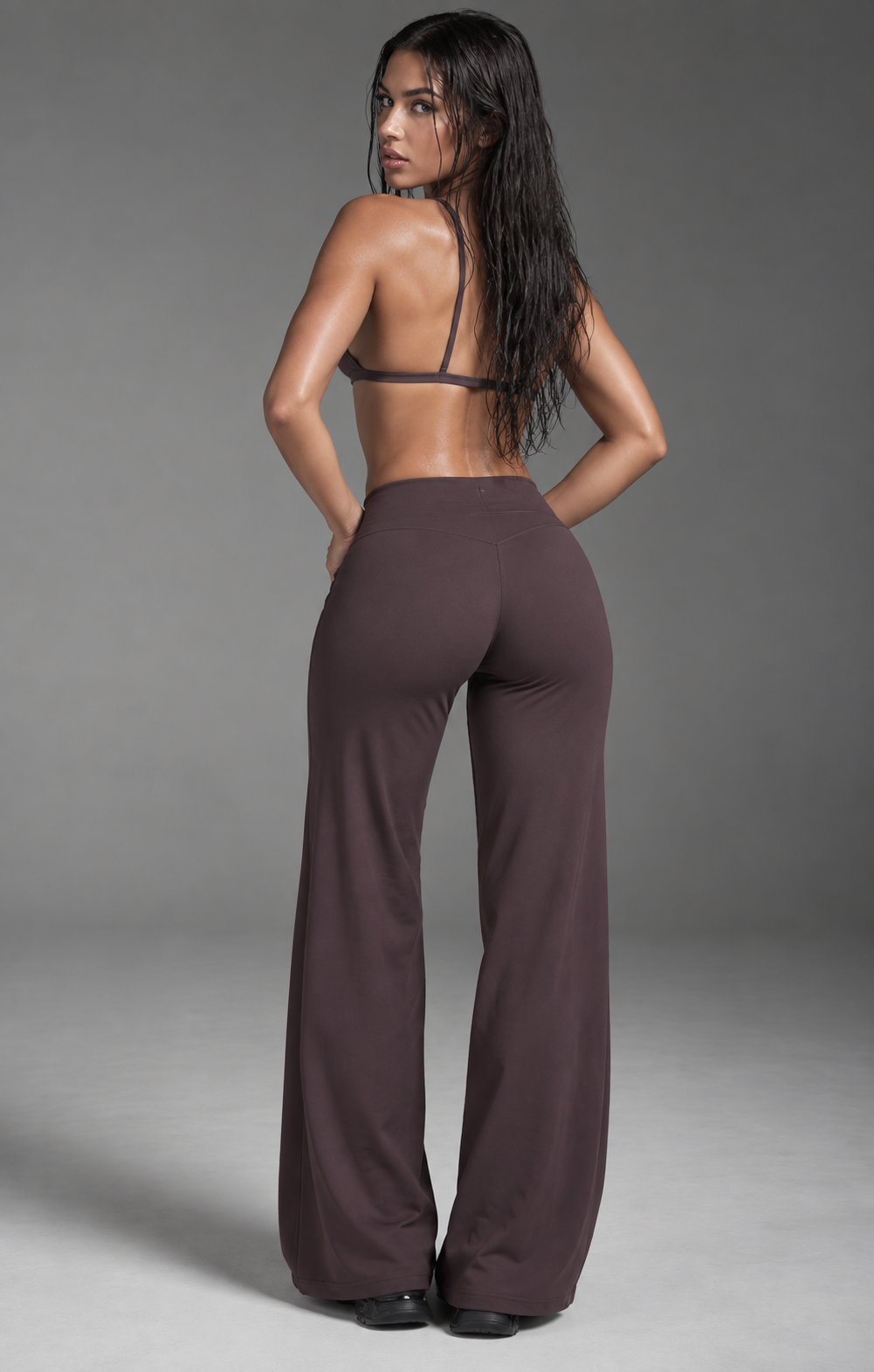 plum women’s activewear co ord with delicate back straps, sculpting high rise waistband and flowing full length trousers