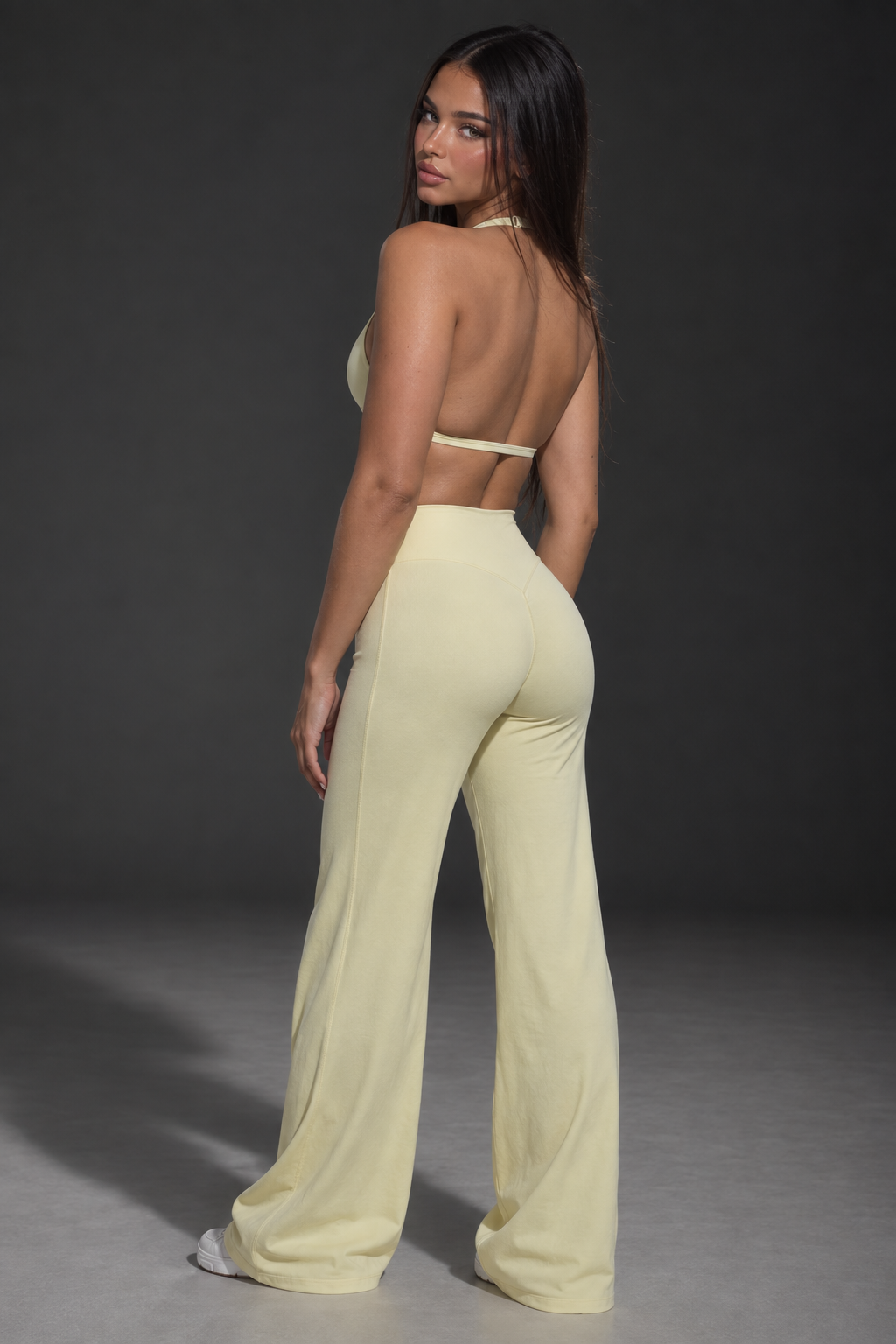 pastel yellow women’s activewear co ord with delicate halter straps, supportive cropped bra and flowing full length workout trousers