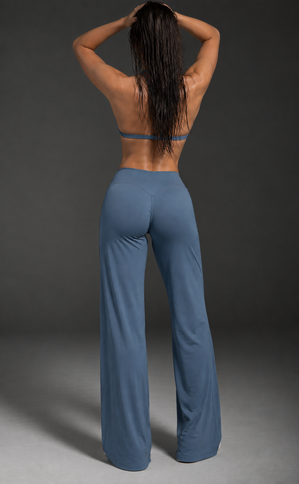 Slate blue women’s activewear co ord with delicate halter straps, supportive cropped bra and flowing full length workout trousers