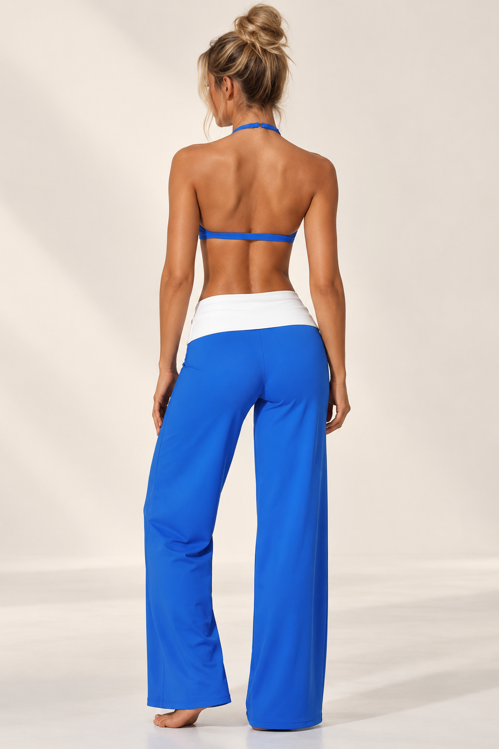 Intense azure women’s Pilates three piece featuring a streamlined cropped performance jacket, matching training bra and fluid wide leg lounge pants