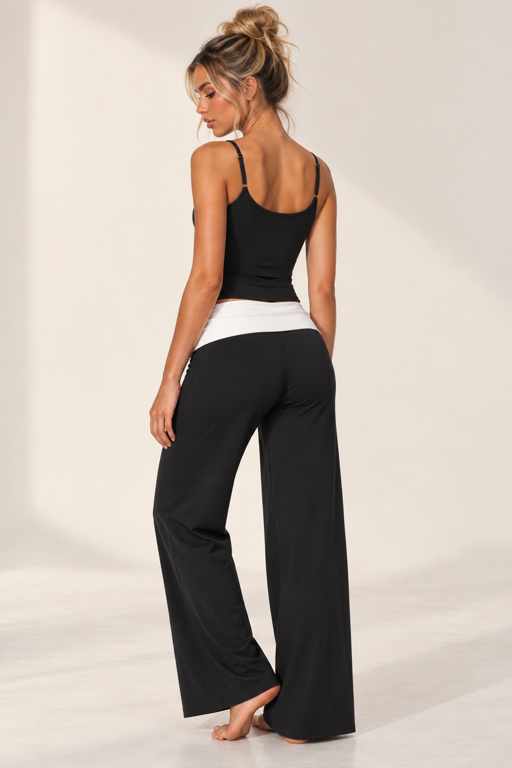 black women’s luxury workout ensemble featuring a high collar zip-up crop jacket, sculpting sports bra and contrast-band wide leg pants